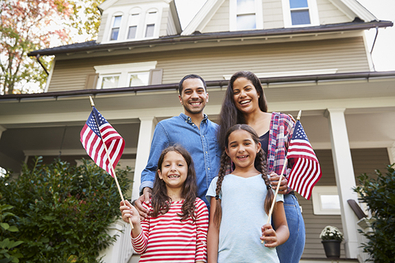 family standing in front of house